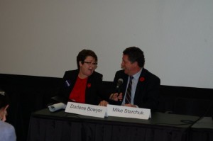 Mike Starchuk sharing a smile and the mic, with an opponent, at the Downtown BIA's All Candidates Meeting, at Surrey's SFU Campus - MikeStarchuk.com