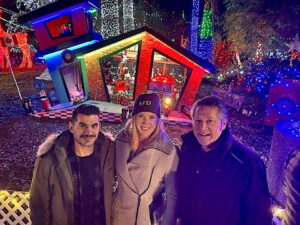 Bright Nights volunteers Greg Georgas (left) and Amanda Roman with Surrey-Cloverdale MLA Mike Starchuk, a retired Surrey firefighter, at the holiday attraction in Stanley Park, Vancouver, on Wednesday, Nov. 29, 2023. (Photo: Tom Zillich)
